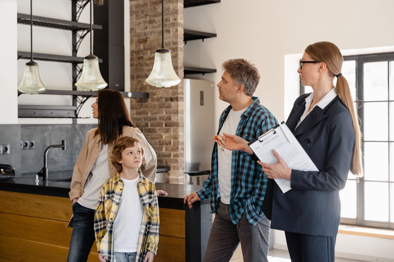 Crafting Captivating Headlines: Your awesome post title goes here A family converses with a real estate agent about a modern home interior.